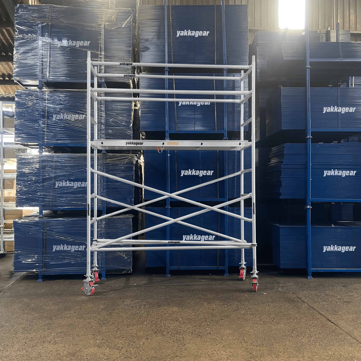 Front view of a 4.6m reach slim scaffold with 2.6m platform height, 2.5m length x 1.3m wide, set up inside a warehouse, Yakka Gear Australia.