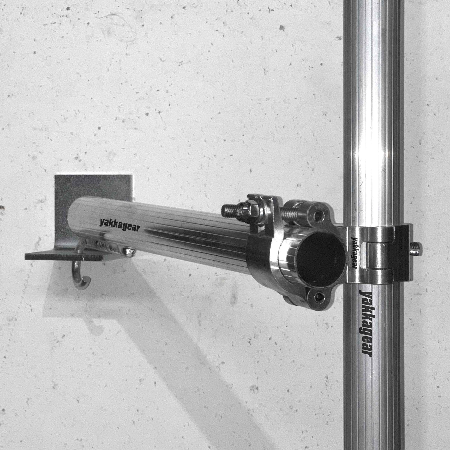 Yakka Gear scaffold wall mount in use on a wall, securely fastening 50mm–51mm tubing to stabilise Slim, Wide, and Compact scaffolds in tight workspaces, eliminating the need for outriggers, Australia.