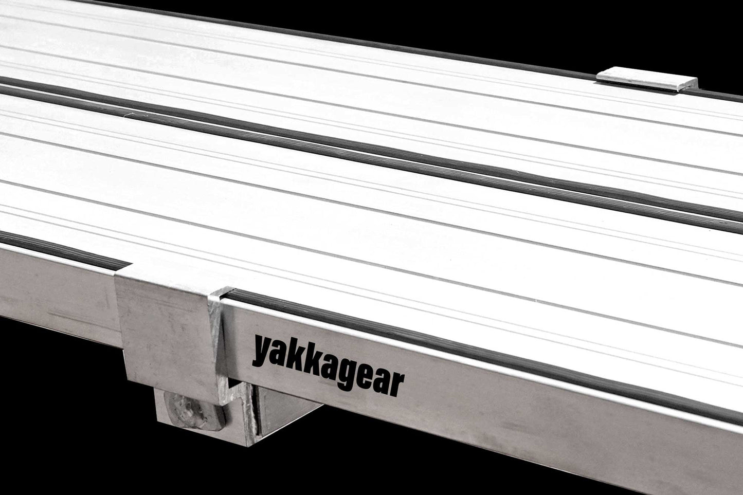 Yakka Gear Australia Plank Clamp being used on two Aluminium Planks as access equipment. Joins two planks together to make the work platform twice as wide and twice as stable. Reduces flex. Used on all sized planks including 2.4m, 3m, 3.6m, 4m, 5m and 6m planks.