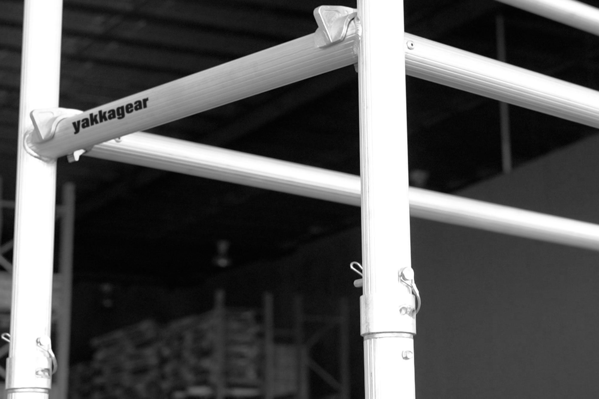 Yakka Gear Australia compact scaffolding tower as access equipment, close up of aluminium frame. 1.44m Length x 0.74m Width, with working platform heights ranging from 1.2m to 3.9m and reach between 3.25m to 6m. View from the front side angle set up in the warehouse.