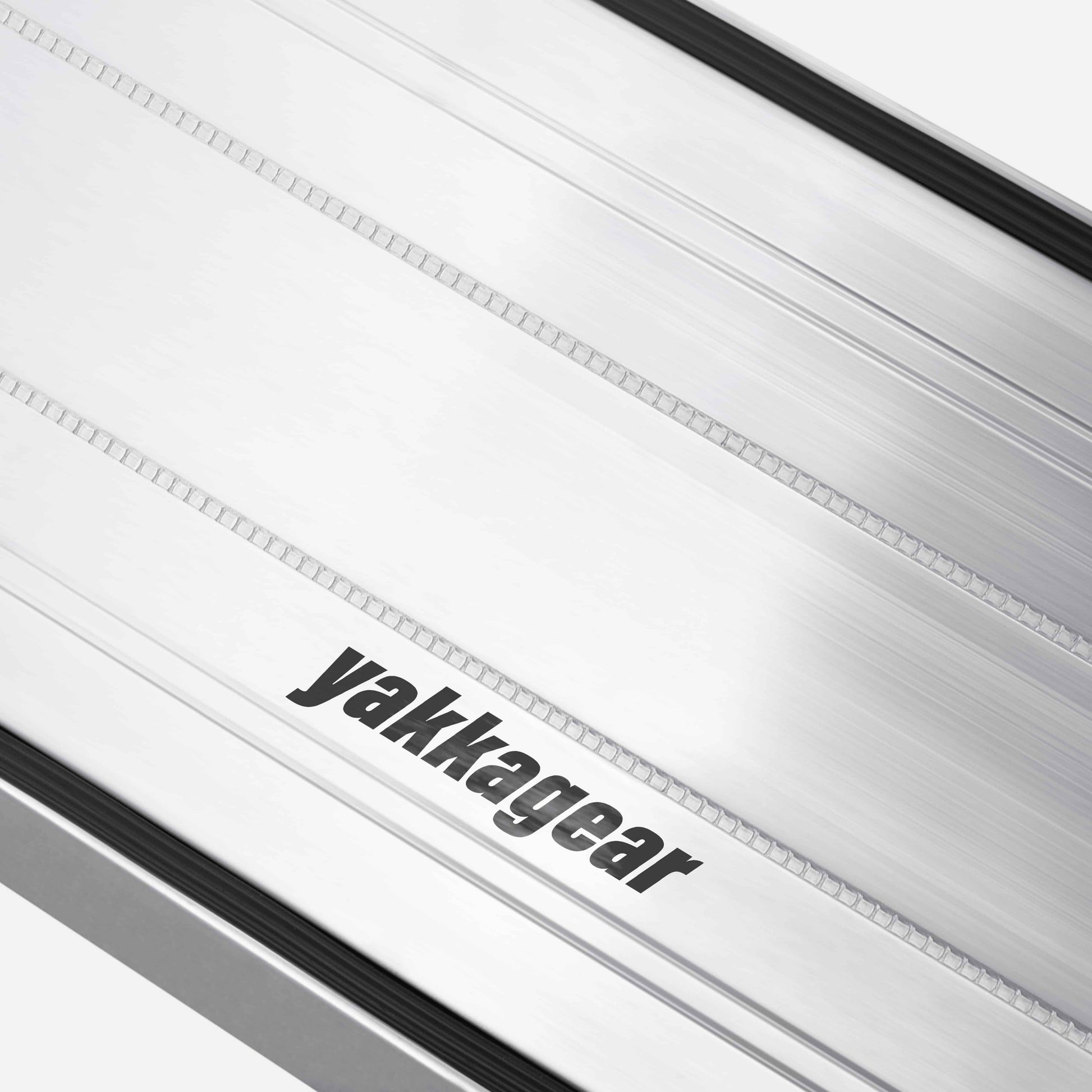 Close-up of an aluminium plank against a white background, highlighting the detailed non-slip aluminium treads and the removable rubber inserts. The image focuses on the traction-enhancing surface design, offering a clear view of the safety features used by tradies for secure footing on worksites.