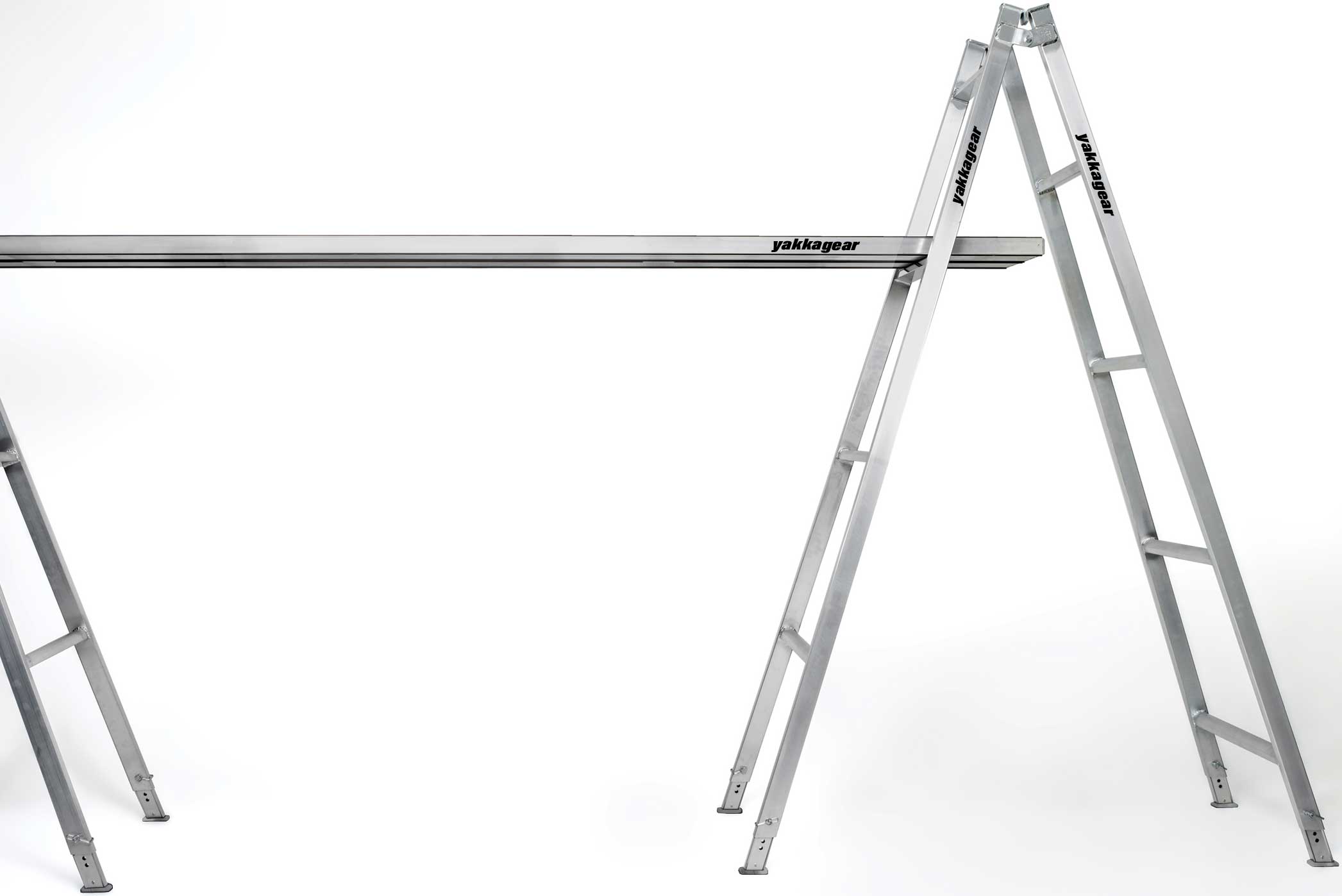Yakka Gear Australia Aluminium Trestles as access equipment. Various sized trestles available including 1.8m, 2.4m, 3.0m, 3.6m, 4.2m, 4.8m. All the trestles are adjustable by 260mm. View from the side being used with planks on a white background. 