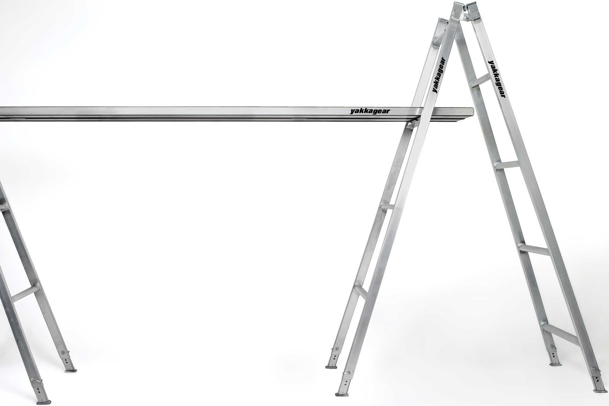 Melbourne Made Adjustable Aluminium A-Frame Trestle Ladders from Yakka Gear. Available in sizes 1.8m, 2.4m, 3.0m, 3.6m, 4.2m, and 4.8m. All adjustable to be higher by 26cm on each leg. Being used with a plank across two trestles.