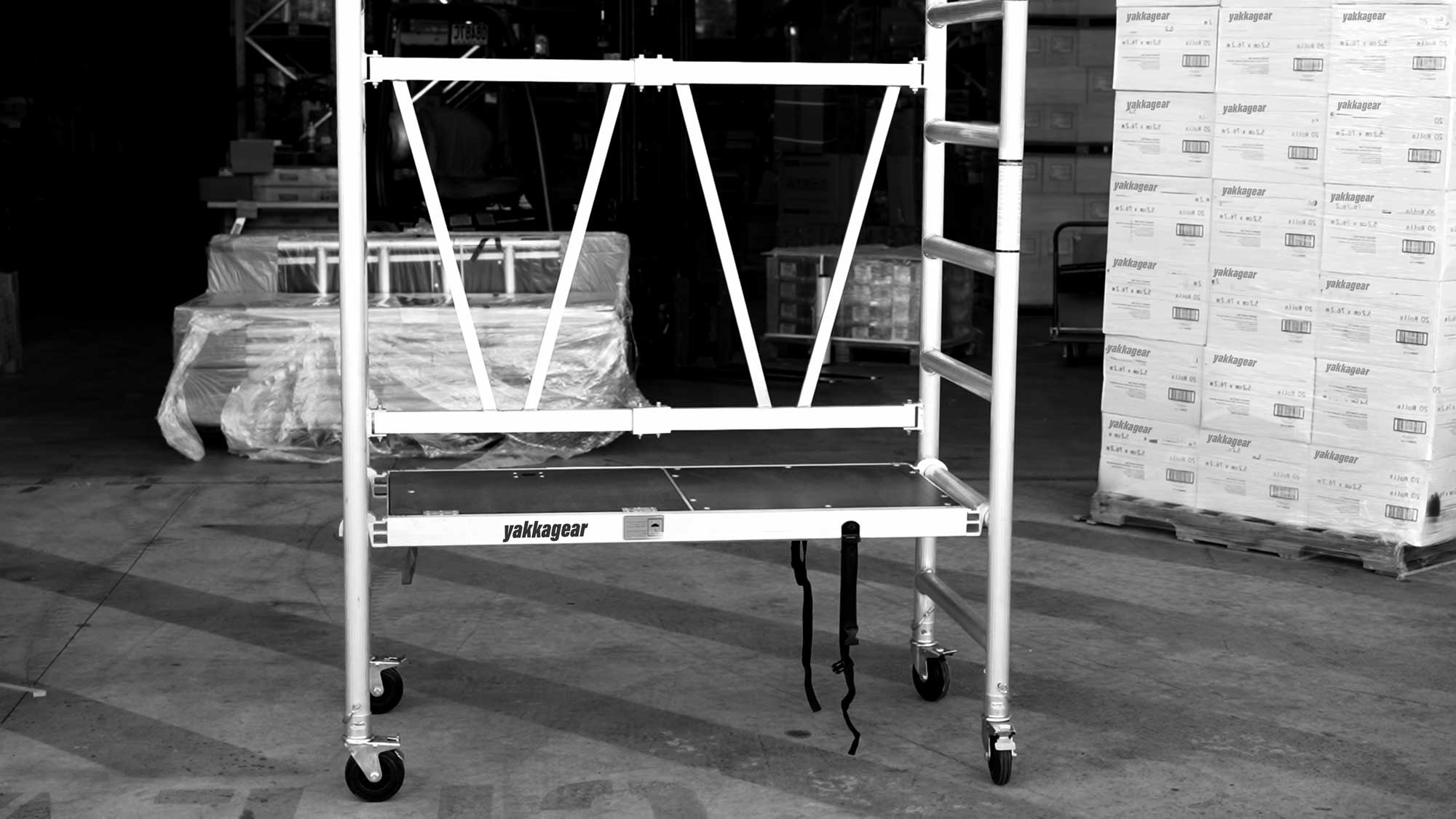 Yakka Gear Australia Base Unit, 1.44m Length x 0.74m Width, with working platform height of 1.2m and reach up to 3.25m high. View from the front side angle set up in the warehouse.